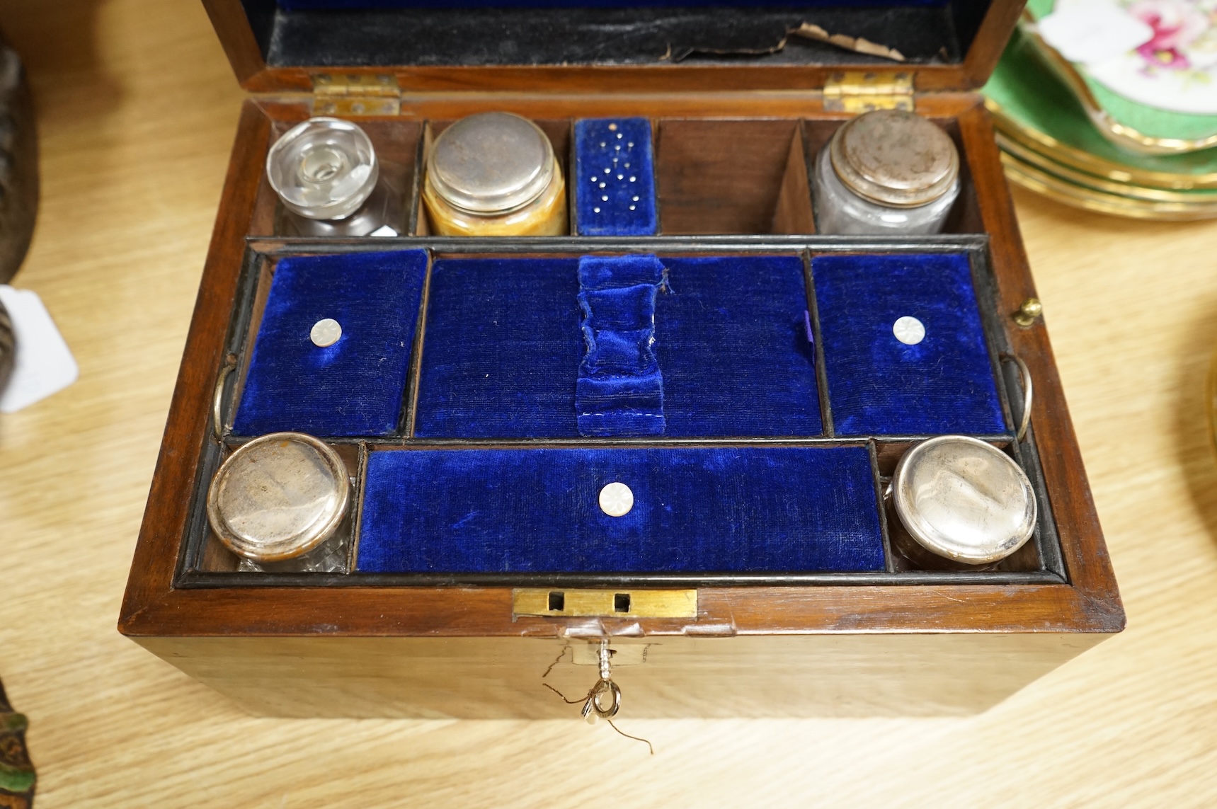 A 19th century walnut toilet box, fitted with glass and plate topped fittings, 27.5cm wide x 17cm high